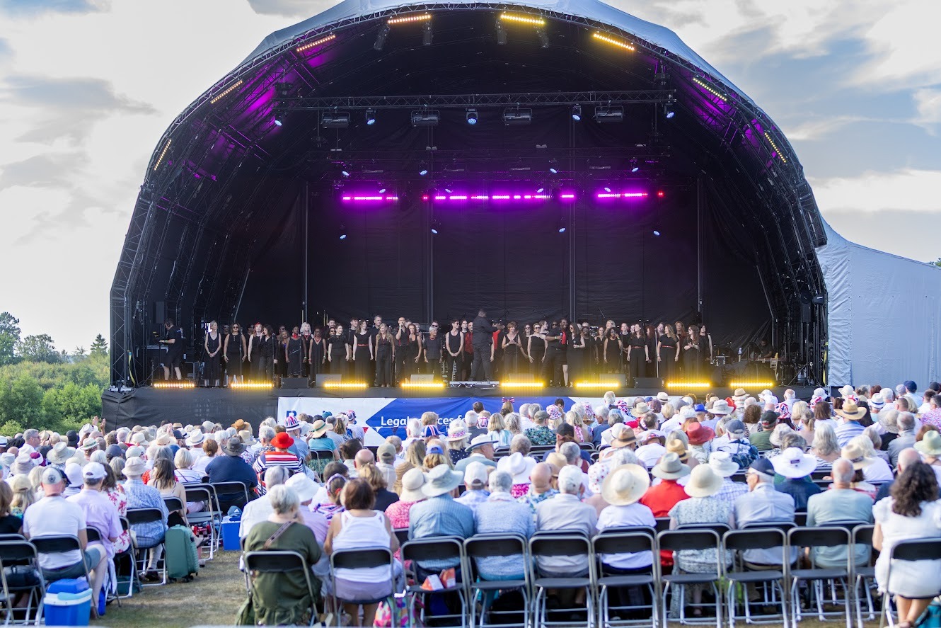 An orchestra on stage in front of a seated audience at the Leeds Castle Concert